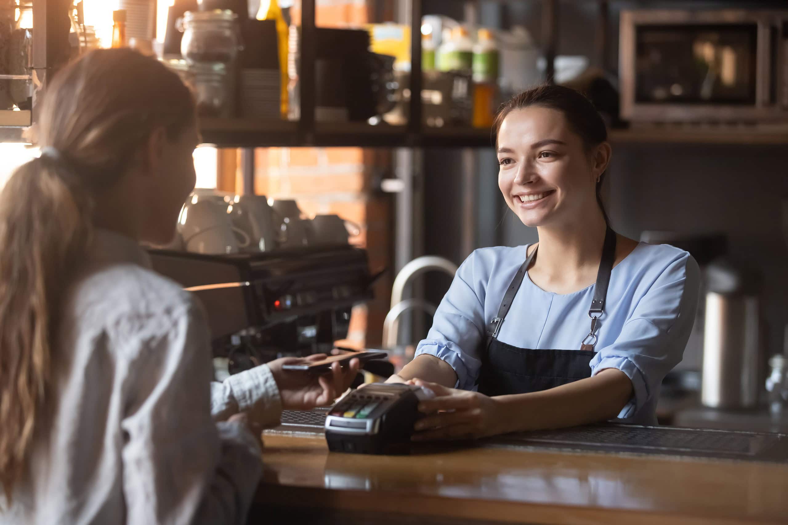 A happy employee accepting payment from a customer